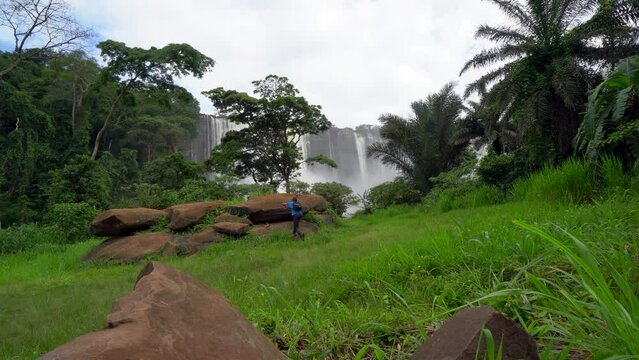 A man walking towards the famous Kalandula waterfall in Angola, Africa