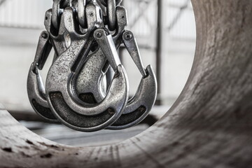 Lifting mechanism iron chain with a hook of an overhead crane on the background of an industrial...