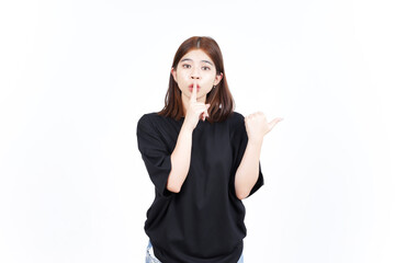 Shh gesture, Presenting and Pointing Side Product Using Thumb Of Beautiful Asian Woman