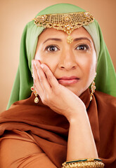 Portrait, muslim and beauty with a model woman in studio on a beige background for skincare or tradition. Face, fashion and culture with an attractive maturre islamic female proud of her heritage