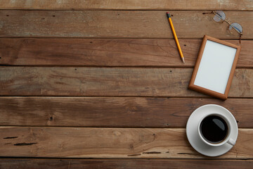 top view of vintage wooden desk with office supplies. copy space