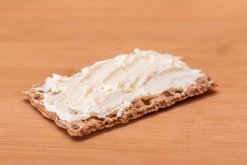 Whole Grain Crispbread with Cream Cheese on Bamboo Cutting Board. Quick and Healthy Sandwiches. Healthy Dietary Snack