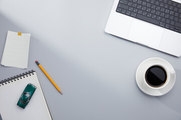 top view of simple gray desk and office supplies with natural window lights. copy space