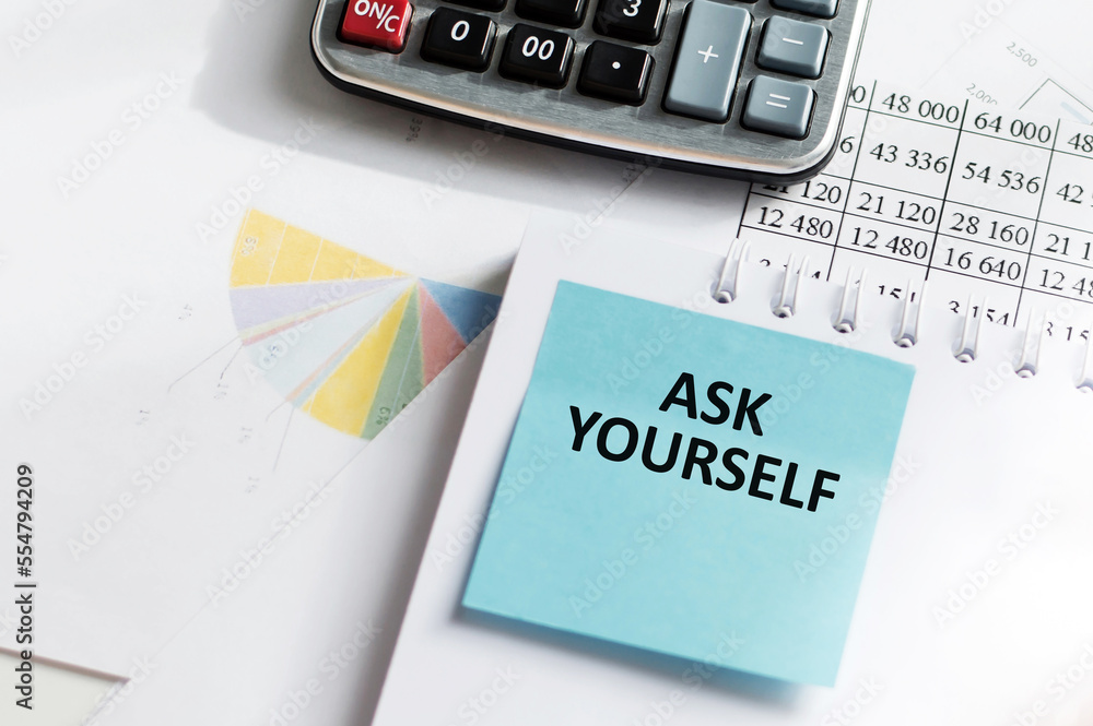 Poster a white card with the text ask yourself stands on a clip for papers on the table against the backgro