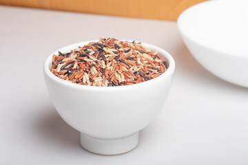 Raw riceberry in white cup.Healthy food.