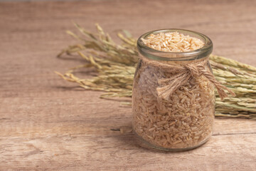 brown Jasmine rice on dark wood background with copy space, healthy food