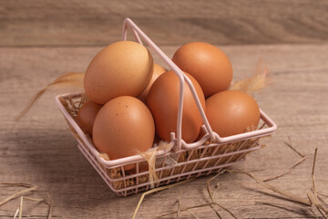 Fresh eggs in a basket on a wooden background.Copy space.