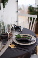 table with dinnerware for Christmas or new year, holiday home table decoration, real photo of table with dinnerware, dining room interior