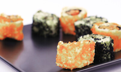 set of Sushi rolls on black plate
