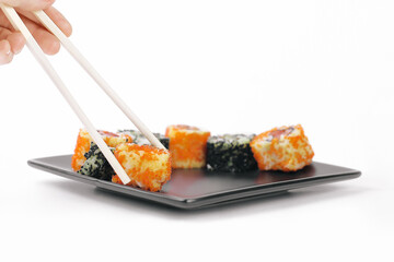 closeup.sticks and a set of Sushi rolls