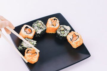 closeup.sticks and a set of Sushi rolls