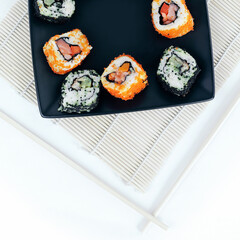 different types of Maki sushi on a black plate