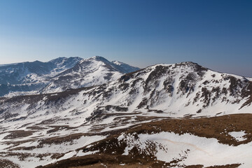 Panoramic aerial view from Hohe Ranach of snow capped mountain peaks of Zirbitzkogel and Kreiskogel, Seetal Alps, Styria (Steiermark), Austria, Europe. Idyllic hiking trail on sunny early spring day
