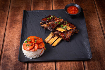 lamb ribs steak with sauce on a wooden background