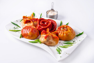 fried manti with sour cream on a white background