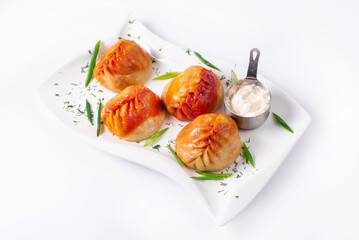 fried manti with sour cream on a white background