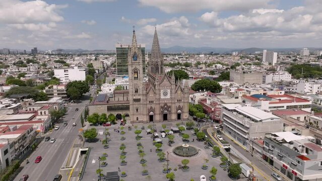 Historic Church Templo Expiatorio del Santisimo Sacramento And Expiatorio Park In The City Of Guadalajara In Jalisco, Mexico. aerial pullback