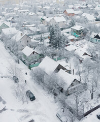 Fototapeta na wymiar Snow covered rooftops of houses.