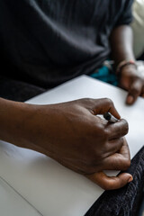 close up of a person holding a pencil