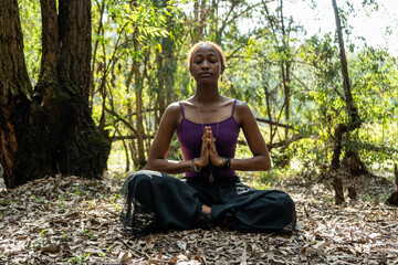 woman doing the lotus pose in nature