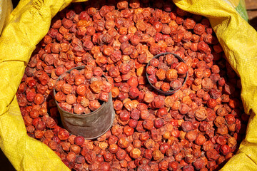 Street market,  detail of dried, red colored jujuba fruits in yellow bag. Madagascar food,...