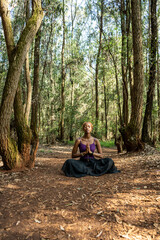 lotus pose in the woods