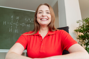Happy chemistry teacher wearing red polo shirt