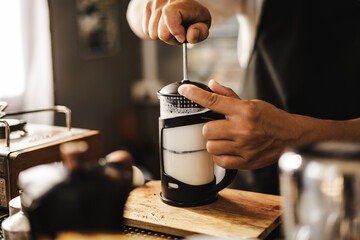 Barista pump and shake milk for frothy ,when mix latte coffee