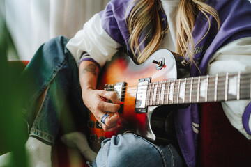 Hand of guitarist playing guitar in studio