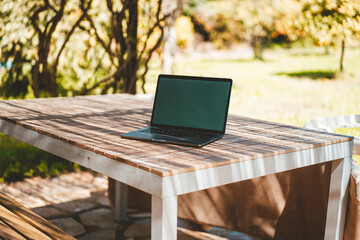 Laptop on table in garden