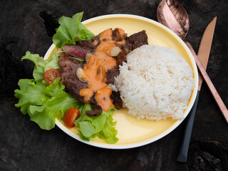 Beef rib eye steak with rice and vegetable. Healthy balanced food concept. topped spicy sauce.
