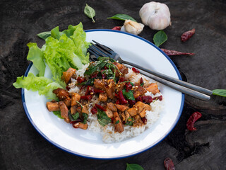 Topped Chicken Pad Kee Mao with rice and basil. Thai spicy food.