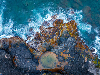 Amazing black rocks on the coastline. Breaking waves on the cliffs. mother earth natural power is on the photo. splandid geological formations