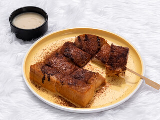 Toast topped with sweetened condensed milk and chocolate.