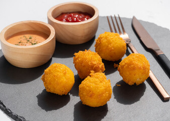 Deep fried Cheese balls. Delicious homemade appetizer. Freshly baked served with tomato ketchup and sauce.