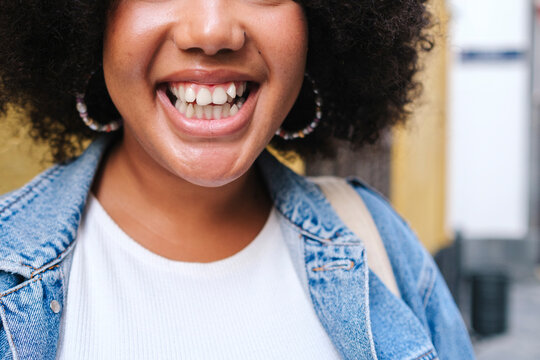 Cheerful young woman showing toothy smile