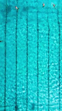 group of swimmers training in an outdoor pool aerial timelapse video