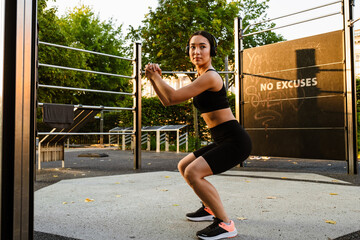 Young asian woman doing exercise during workout on playground