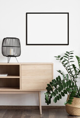 Blank frame mockup in modern interior design with trendy plant on empty white wall background, Horizontal template for painting, photo or poster. Artwork mock-up