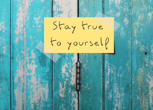 Old vintage blue door background with handwritten text - STAY TRUE TO YOURSELF means to have self awareness, knowing your own values, beliefs, preferences and be who you actually are