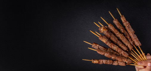 Lamb skewers also called kebabs, or arrosticini or chuan, are small pieces of meat roasted on...