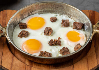 Turkish scrambled eggs Turkish name Kavurmali Yumurta with roasted meat in copper pan