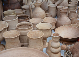 Fototapeta na wymiar Handmade Ceramic Pottery in a Roadside Market with Ceramic Pots and Clay Plates.