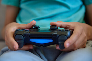 Boy playing video game at home, Online entertainment and leisure activity