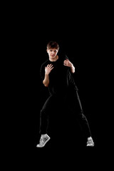 young man in black t-shirt and jeans dancing