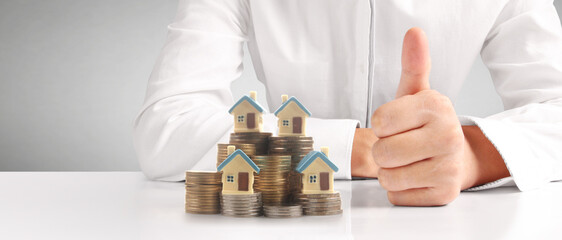 House Residential Structure in hand ,model house and coin