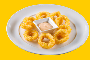 Delicious fried food, fried squid rings.on yellow background