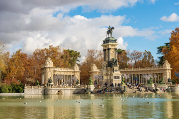 Fototapeta na wymiar Madrid, monument to Alfonso XII (King of Spain) in Buen Retiro Park (Parque del Buen Retiro) with the small lake and the public park. Community of Madrid, Spain, southern Europe.