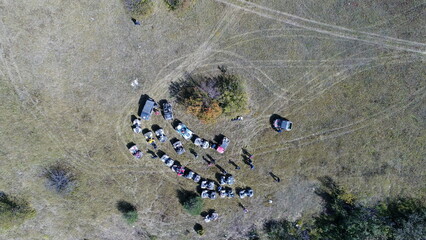 Aerial drone view of ATV quads on a dirt trail in forests. Off-road group team club enthusiasts...