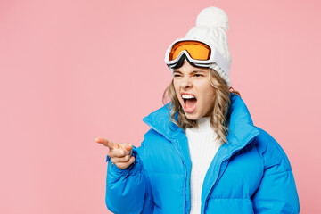Snowboarder sad woman wear blue suit goggles mask hat ski padded jacket point index finger aside on...